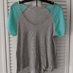 Mint green and grey shirt.